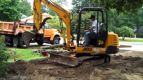 grading with a mini excavator|digging with an excavator.